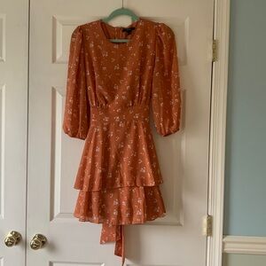NEVER WORN Flowy orange with white flower dress with a bow in the back